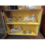 Miniature bicycles in display cabinet
