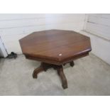 Octagonal mahogany table on castors H74cm Top 107cm x 107cm approx