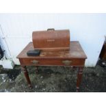 Mahogany table converted into sewing machine table with Singer electric sewing machine and