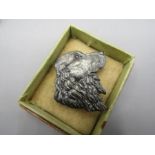 A white metal spaniel brooch