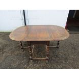 Carved oak drop leaf dining table H75cm W105cm D68cm (when closed) approx