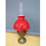 Brass oil lamp with red glass shade