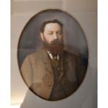 A Victorian studio photograph. Hand coloured head and shoulders portrait of a gentleman, oval