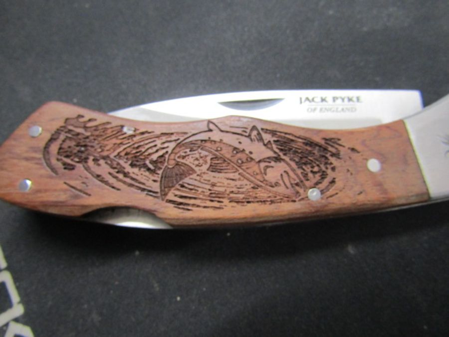A Jack Pyke pocket knife with fishing scene and one other with duck scene