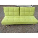 A retro style green sofa bed