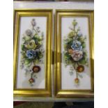 A pair early 20thC continental 3d flower plaques with porcelain flowers on porcelain ground