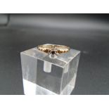 9ct gold dress ring, with six small white stones and one small garnet 1.39g total weight
