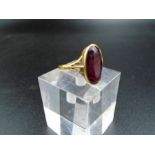 An 18ct gold dress ring with possible garnet. 3.15g total weight
