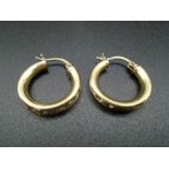 A pair of 9ct gold hoop earings with white stones