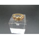 An 18ct gold dress ring, with scroll work, 6 milk white stones 2.95g total weight