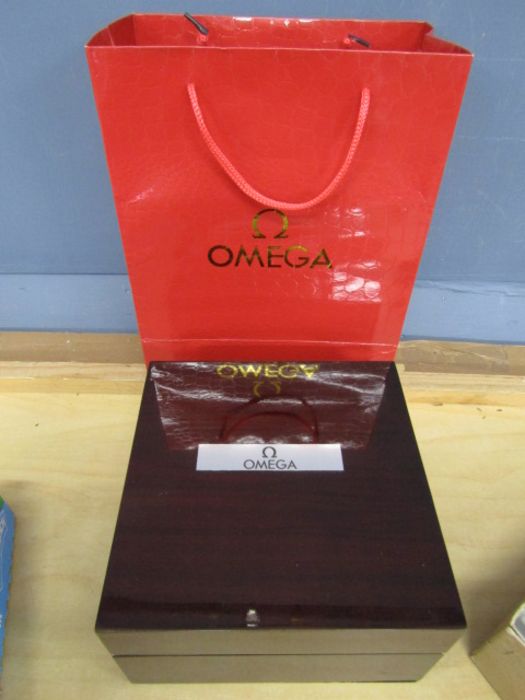 Omega wooden watch box and bag