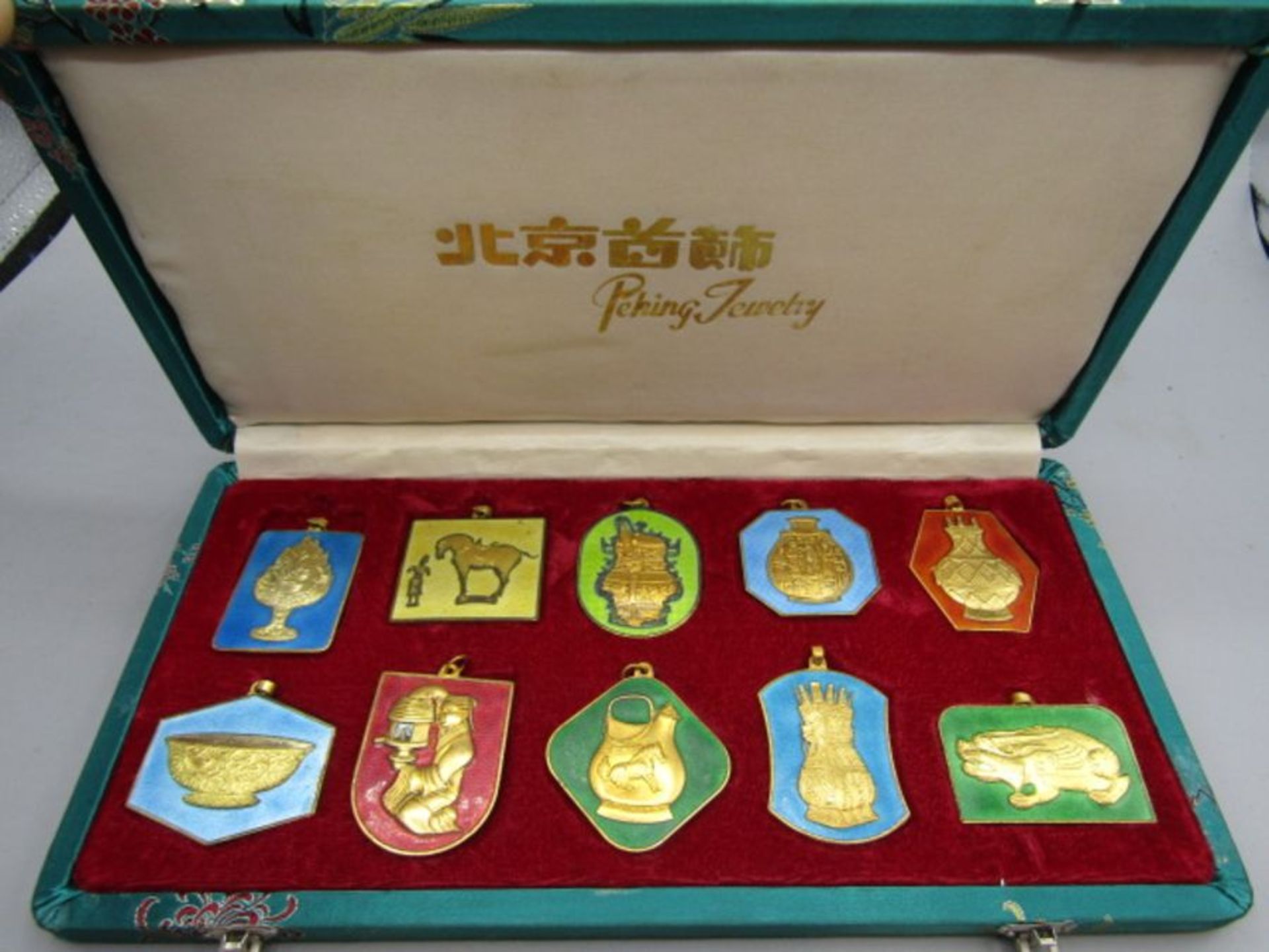 A Set of 10 Peking Jewellery Chinese gilt metal and enamel pendants, inscriptions verso,