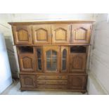Large oak cabinet with 3 drawers and 9 cupboard doors H198cm W202cm D55cm approx (lifts apart into 3