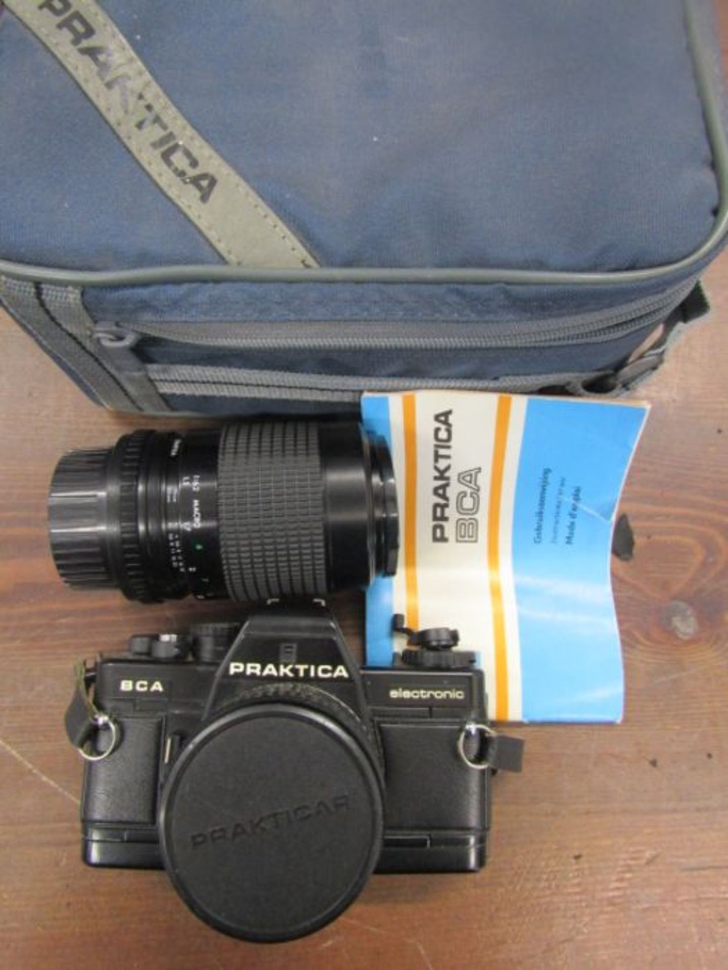 Praktica 35mm BCA camera in carry case with 70-210mm telephoto lens and carry strap