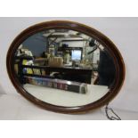 A vintage oval bevelled mirror 68x53cm