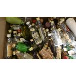 Large box of miniature alcohol bottles including both full and empty bottles.