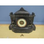 A high black slate mantel clock with gilt detail and enamel face