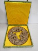 A Chinese ceramic wheel of dragons in presentation box