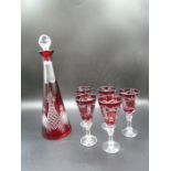Ruby red overlain Bohemian-style cut glass decanter with stopper and 5 similar liqueur glasses