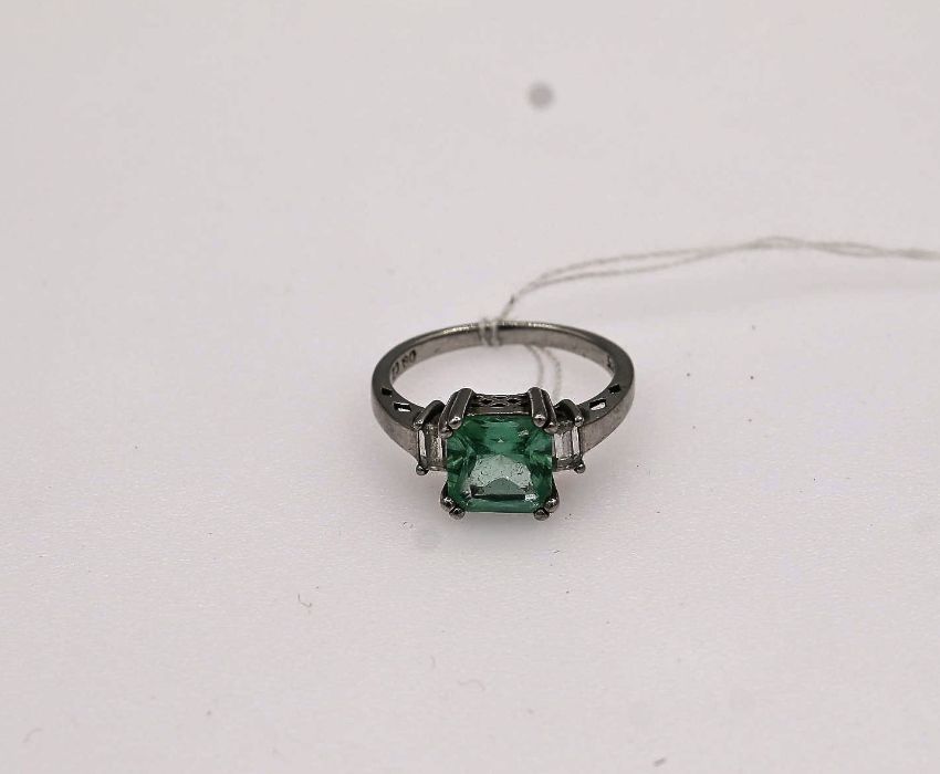 Silver dress ring with a square light green/blue stone and cubic zirconi's size P