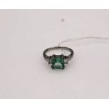 Silver dress ring with a square light green/blue stone and cubic zirconi's size P