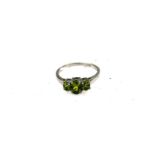 Silver dress ring with 3 graduated claw set oval peridots
