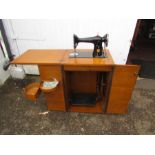 Vintage Singer sewing machine in oak cabinet