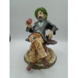 Capodimonte large tramp figurine sitting on a tree bench drinking, approx 27cm tall