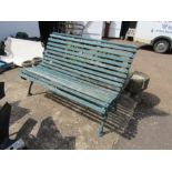 Green bench with cast iron ends and wooden slats