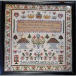 A framed and glazed Sampler dated 1876, by Rosa Grommett (aged 12) Some age related discolouration.