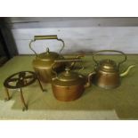 3 copper kettles and a trivet