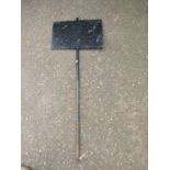 A heavy cast iron sign holder