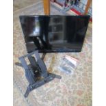 32" Samsung tv with remote along with a tilt and turn tv wall bracket