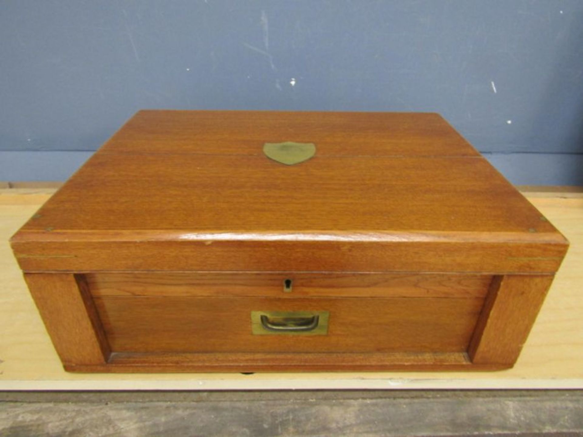 An oak military style canteen of near matching cutlery for 12 settings plated and with large ladle