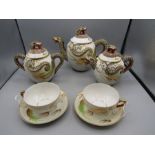A Japanese part tea set- 3 teapots and 2 cups and saucers
