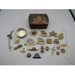 Military badges and pocket watch in vintage toffee tin