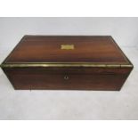 A mahogany writing slope with brass escutcheon and detail, with key