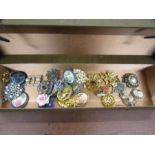 A box of vintage brooches