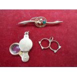9ct gold magnifying glass pendant, 9ct gold mini handcuff pendant and a 9ct gold pin brooch with a