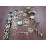 Horse brasses and various brass animals including a parrott