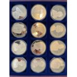 A set of 12 (50mm) 'Portraits of the Queen' gold plated medallions in a box