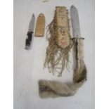 An American Indian style knife with buckskin and tassel case and one smaller knife