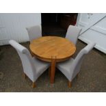 Heavy round oak dining table with 4 upholstered chairs