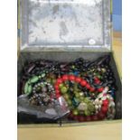 A tin of costume jewellery