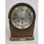 A mantel clock in working condition with brass inscription plate