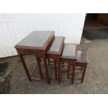 Nest of 4 hardwood tables with carved tops under glass