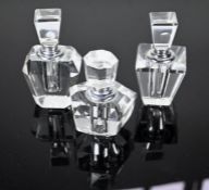 Three glass scent bottles with white metal mounts