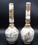 A pair of Japanese Satsuma vases painted birds in a floral landscapes, 38cm tall