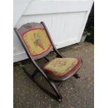 A vintage folding rocking chair