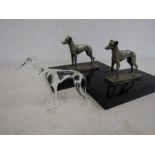 2 greyhound figurines on plinth along with a glass greyhound